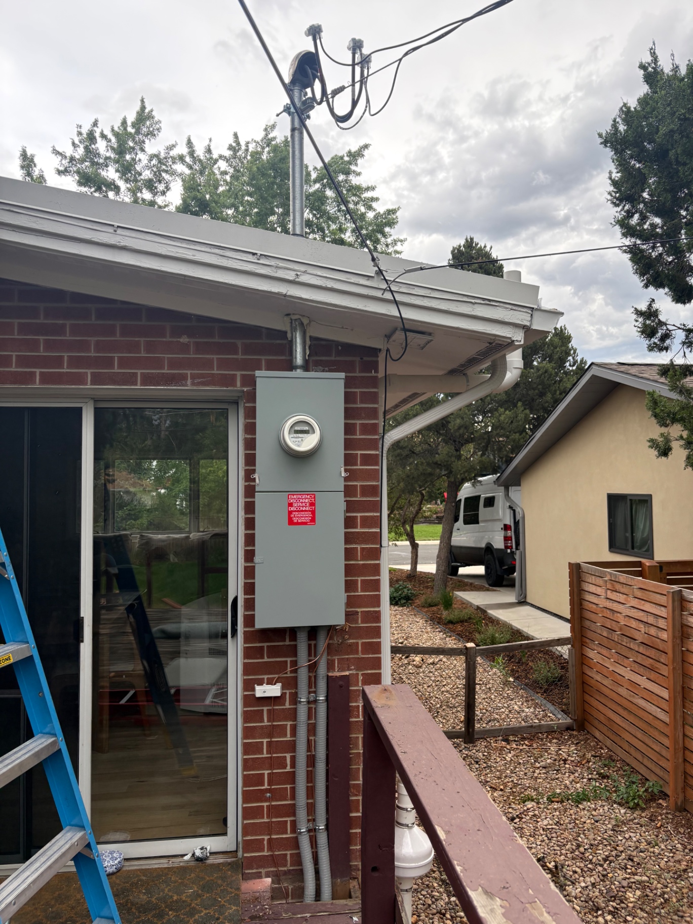 New meter with emergency service disconnect and conduit on a brick home