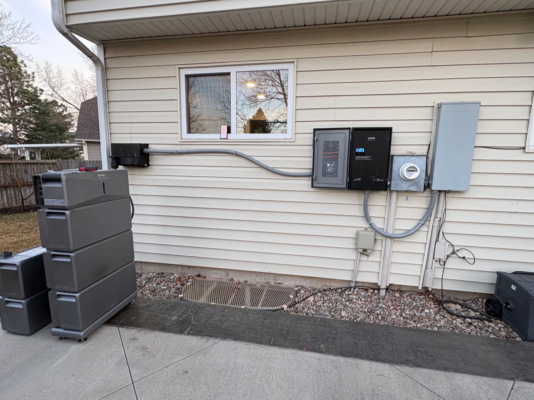 Anker SOLIX battery stack wired to a new load center and meter on a home exterior