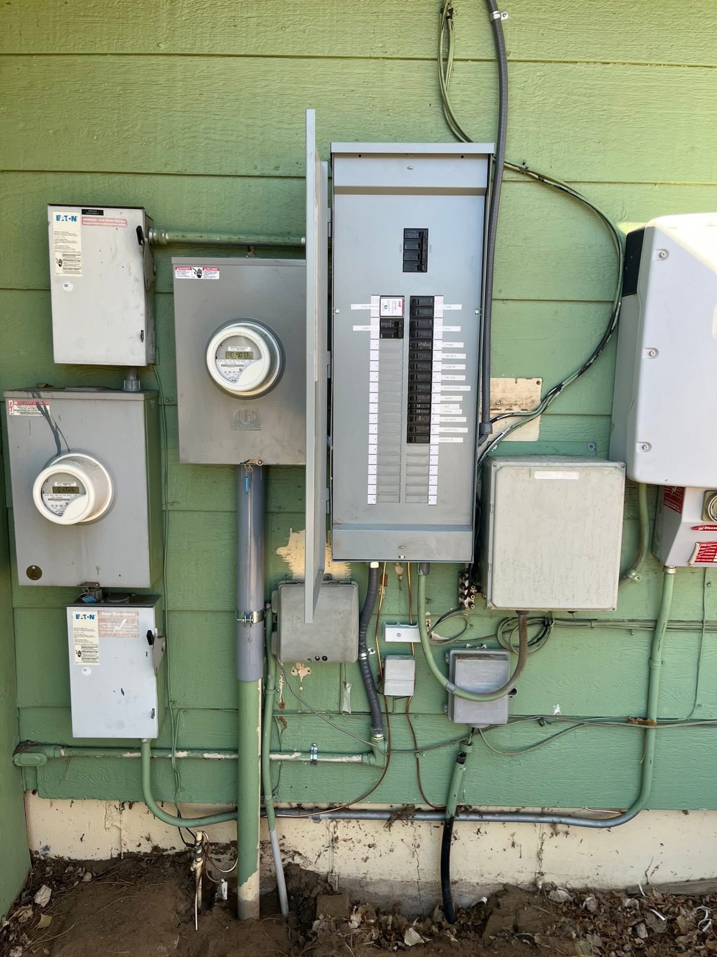 After: new 200 amp load center with printed labels and tidy conduit runs
