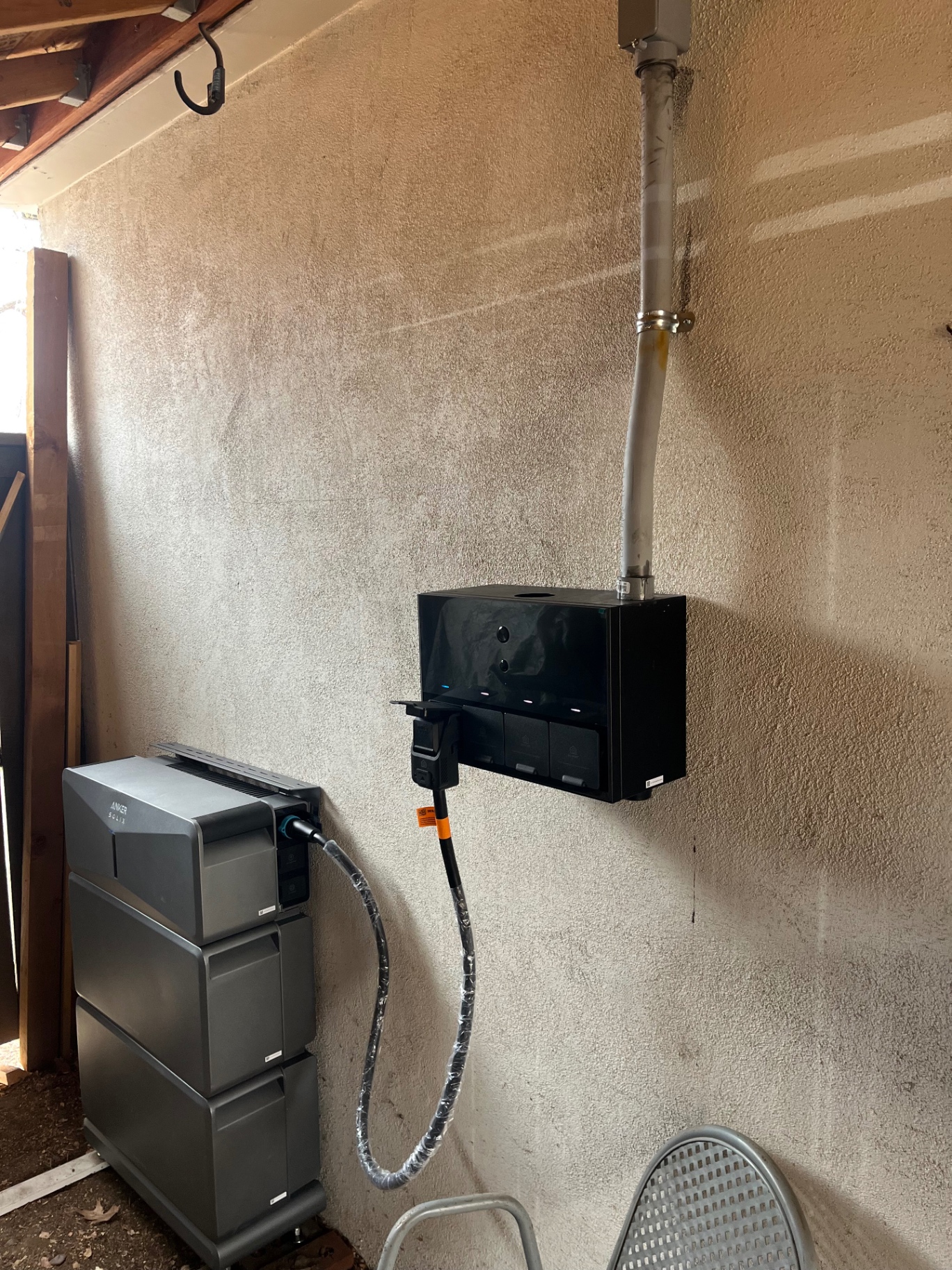Anker SOLIX battery stack and combiner wired to conduit in a garage